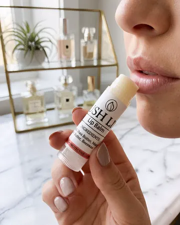 Lush Lips lip balm stick held up to softly moisturised lips